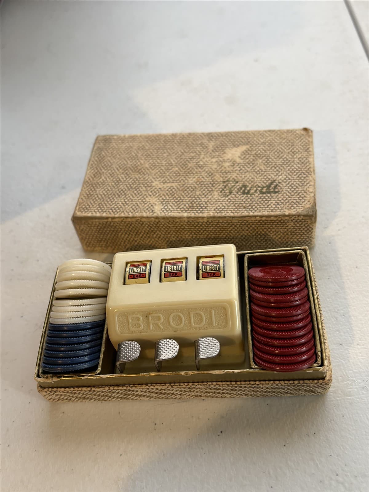 vintage Brodi miniature slot machine w/ some chips, box, Devalera