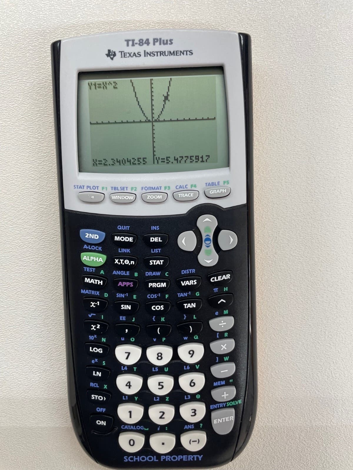 Texas Instruments TI-84Plus Graphing Calculator with School Property markings.