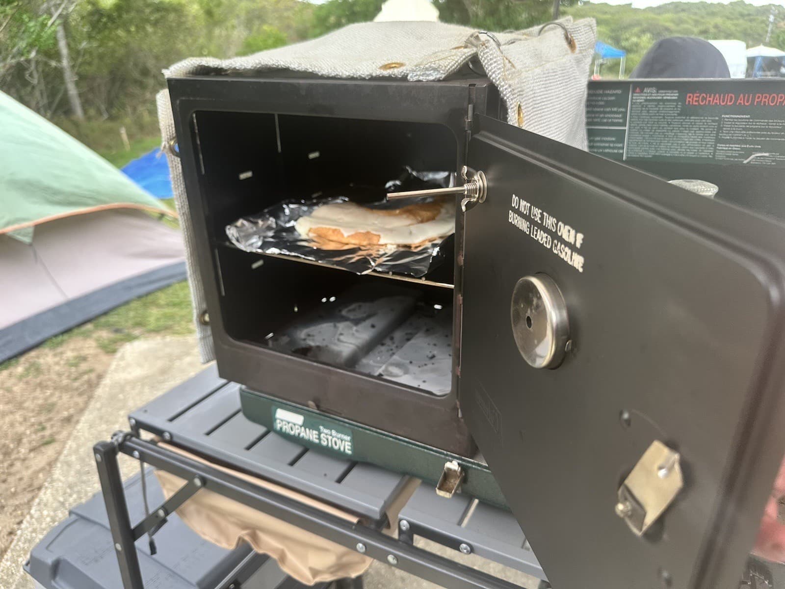 Coleman Classic Camp Oven Thermal Blanket plus an Interior Heat Diffuser plate. 5