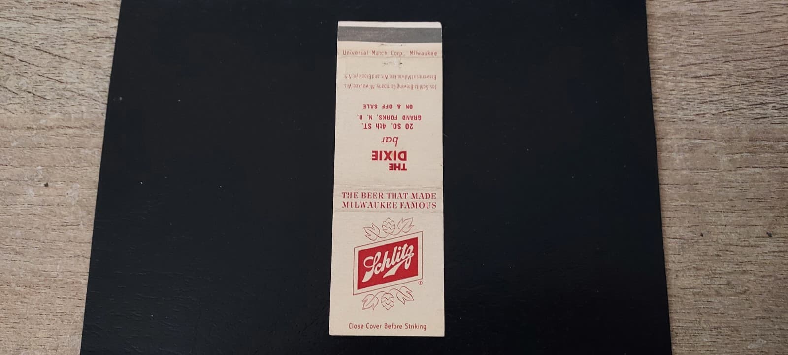 THE DIXIE BAR (SCHLITZ BEER) 20 S. 4TH ST. GRAND FORKS N.D. VINTAGE MATCH COVER