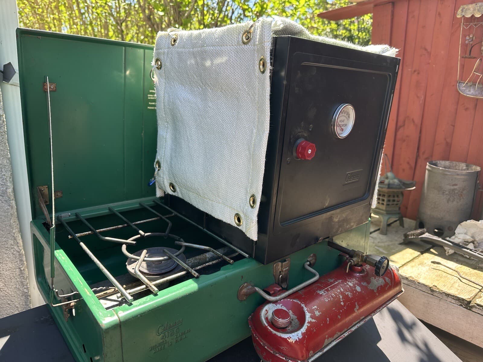 Coleman Classic Camp Oven Thermal Blanket plus an Interior Heat Diffuser plate. 2